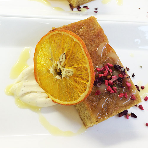 Orange and polenta cake, vanilla cream and dried orange slice
