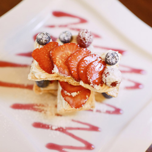 Mille feuille of strawberrys and blueberries with wild strawberry couli